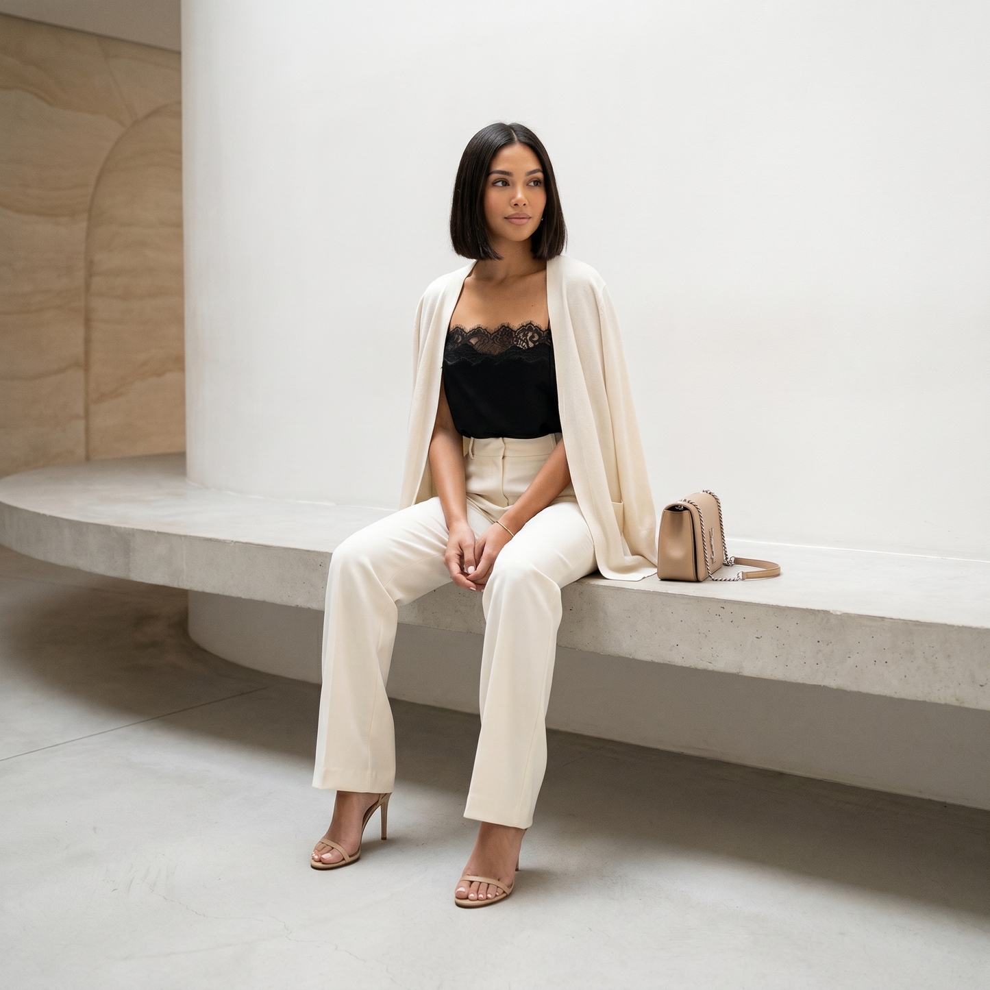 Saga Lace Cami — seated lifestyle styled with cream trousers and cardigan
