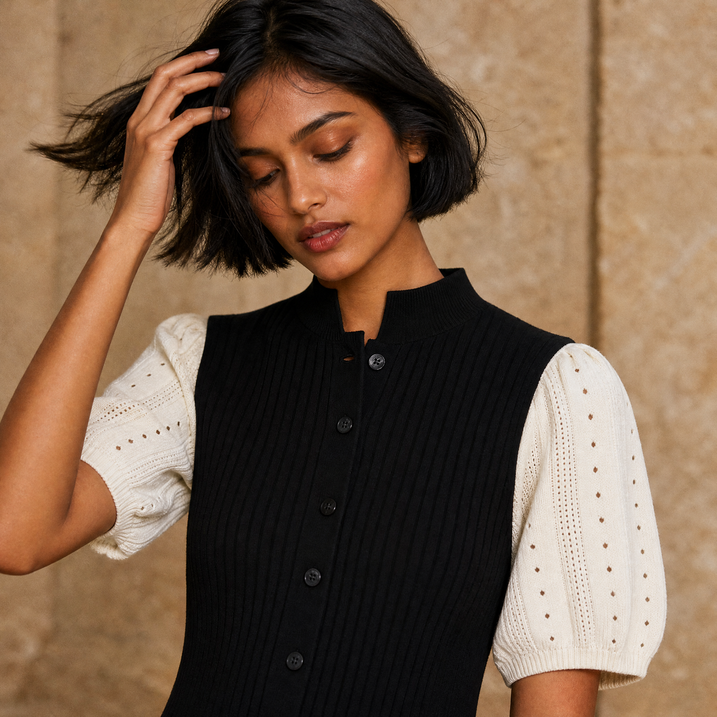 Selene Knit Maxi — waist-up motion, hand through hair, contrast sleeve visible