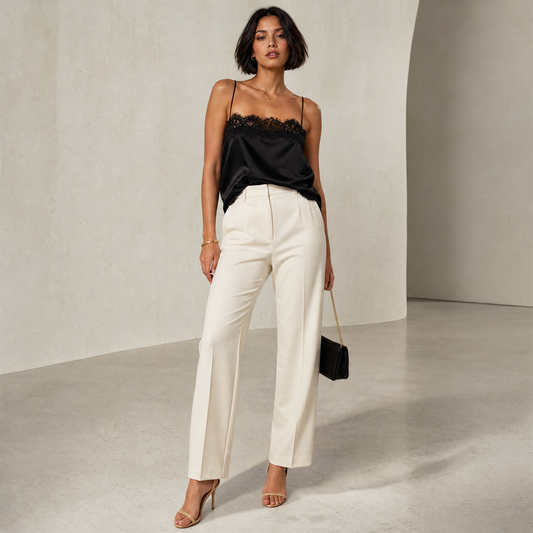 Saga Lace Cami in Black — hero shot styled with cream trousers