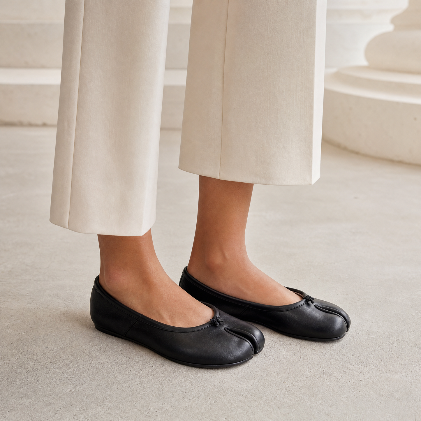 Iris Tabi Flat in Black — on-model with cream wide-leg trousers